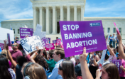Pro-choice activists rally to stop states' abortion bans in front of the Supreme Court in Washington, DC